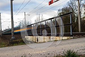 Fast train passing under a bridge on a lovely summer day motion blurred image