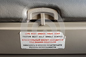 Fasten seat belt while seated symbol on the back of an airplane seat