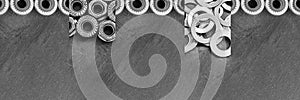 Fasteners collage. Horizontal long banner with different kinds of screws, rivet nuts. Black and white metal details. Close up.