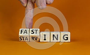 Fasting or starving symbol. Doctor turns wooden cubes and changes the word `starving` to `fasting`. Beautiful orange backgroun