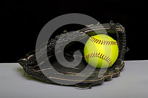 Fastpitch Softball Fielders Mitt With Yellow Ball photo