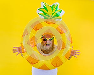 Fat amazed man with wig in head is ready to swim with a donut lifesaver