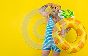 Fat amazed man with wig in head is ready to swim with a donut lifesaver