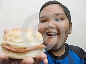 Fat Asian boy enjoys fast food