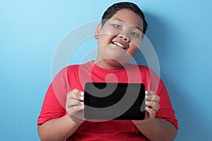 Fat Asian boy shows his tablet screen, tablet smart phone mock up
