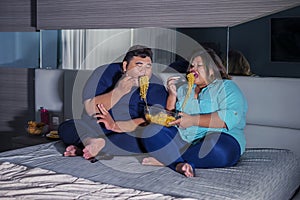 Fat Asian couple gaping at noodle gluttonously