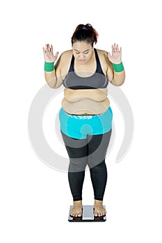 Fat Asian woman measuring her body weight