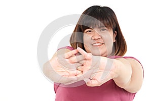 Fat Asian woman smiling brightly. Exercise arm stretching Stay on a white background.