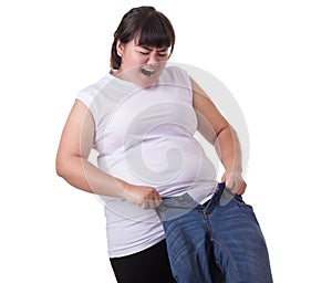 Fat asian woman trying to wear small size jeans isolated on whit