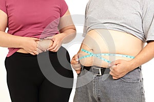 Fat Asian women and man use a Blue tape measure. Measure your belly size.