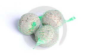 Fat balls for feeding wild garden birds, suet, in nets, isolated
