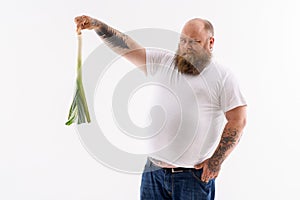 Fat bearded guy staring at vegetable