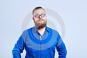 A fat, bearded man clever with glasses with a clever stupid expr