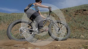 Fat bike or fatbike or fat-tire bike in summer driving on land and sand.