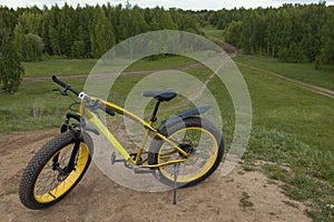 Fat bike at summer countryside - dirty bicycle, horizontal