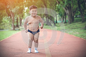 Fat boy enjoy exercise jogging in the park
