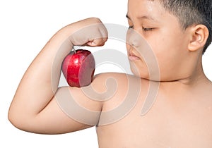 Fat boy flexes him muscle while showing off the apple that made