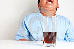 The fat boy has a phantom. After drinking a sodden, there is a soda.