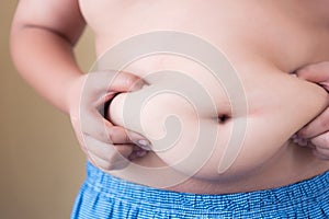 Fat boy with overweight checking out his weight  on white background