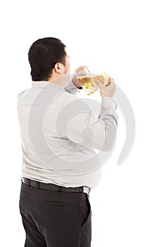 Fat business man is overeating. isolated on a white photo