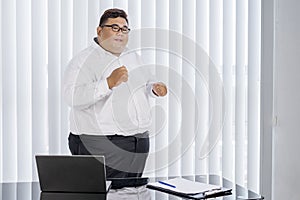 Fat businessman cheering and dancing for his work