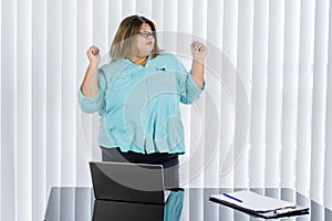 Fat businesswoman cheering and dancing for her job