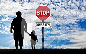 Fat father with a child and a sign of stop obesity