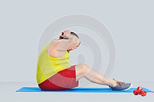 Fat funny man doing exercises on abs