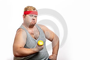 Fat funny man in red headband shows his muscles with dummbell and emotions