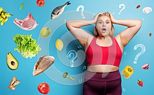 Fat girl in fitness suite wants to start a diet but has doubts about the food to buy. Cyan background