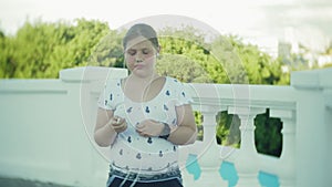 A fat girl running a pulse monitor on a smart clock