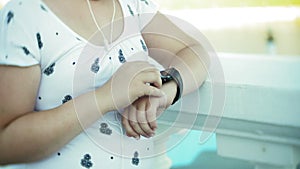 A fat girl running a pulse monitor on a smart clock