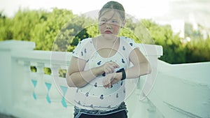 A fat girl running a pulse monitor on a smart clock