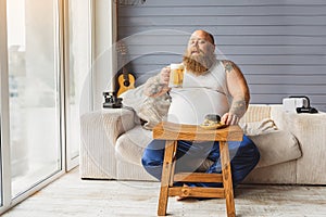 Fat guy relaxing with alcohol drink