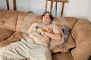 Fat guy sleeping on the couch