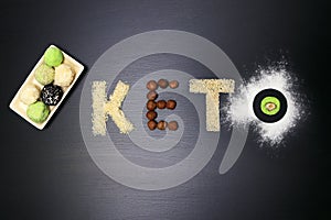 Fat keto peanut butter, cheesecake, matcha balls tea on dark black wooden background. keto protein balls and matcha tea recipes