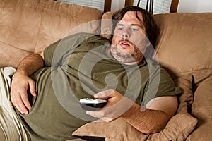 Fat lazy guy on the couch photo