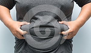 Fat man checking out his weight isolated on white background photo