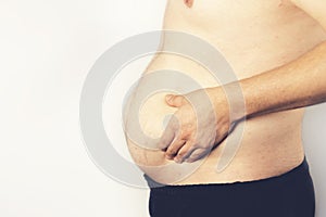 Fat man checking out his weight isolated on white background