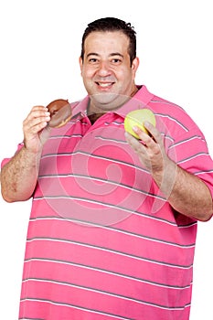 Fat man deciding between a candy and an apple