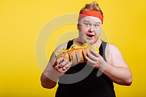 Fat man eating fast food hamberger