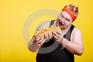 Fat man eating fast food hamberger