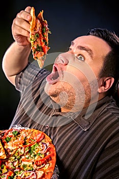 Fat man eating fast food slice pizza . Breakfast for overweight person.