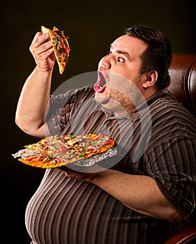 Fat man eating fast food slice pizza . Breakfast for overweight person.