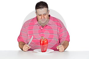 Fat man eating a red pepper