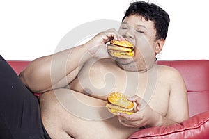 Fat man eats two hamburgers 2