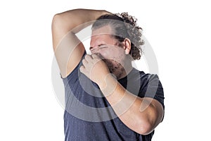 Fat man holds or pinches his nose shut because of a stinky smell or odor