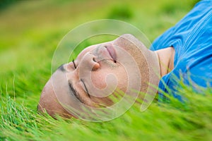Fat Man Lying on the Green Grass to Relax