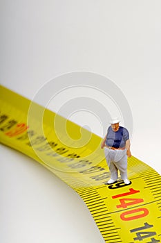 Fat man on a measurer - miniature
