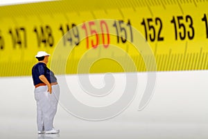 Fat man on a measurer - miniature